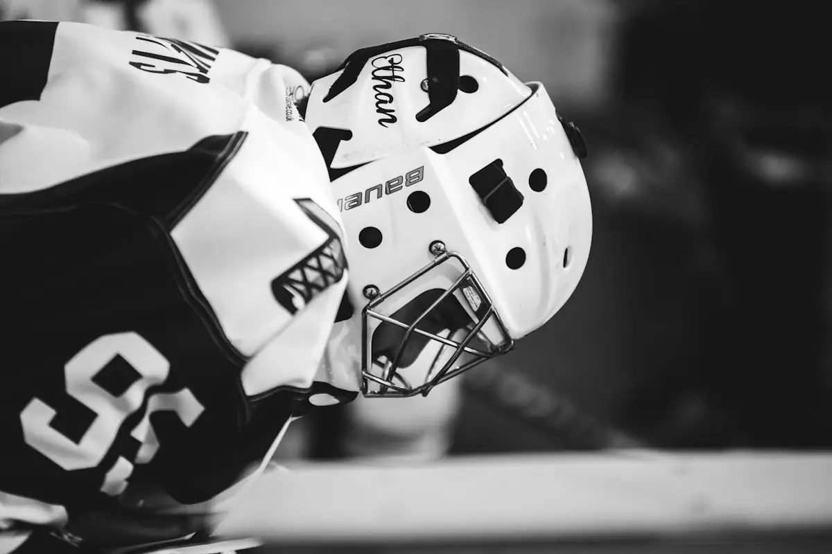 Close-up of a goaltender in a white mask